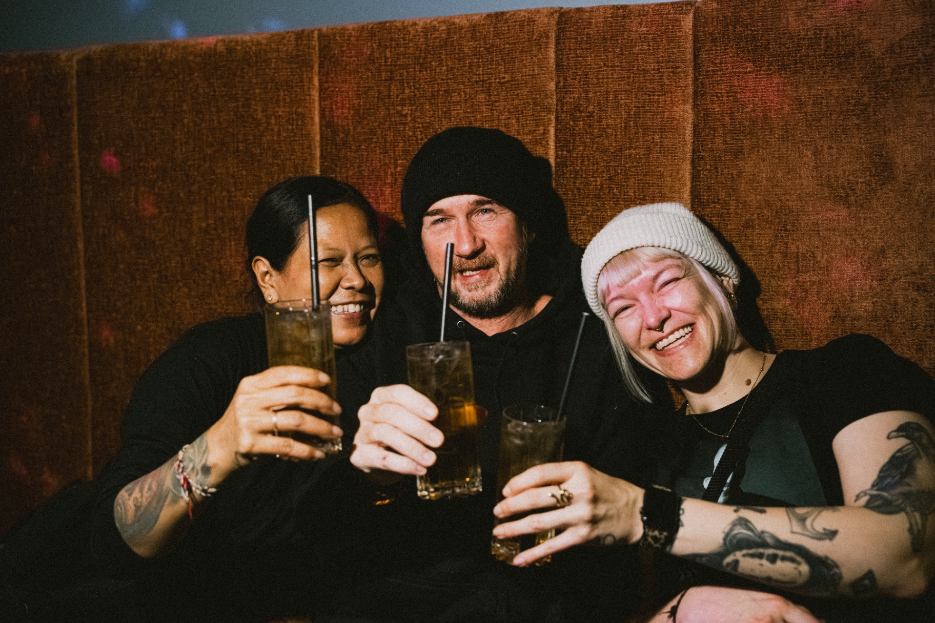 Three guests raising their drinks at Jimmy's