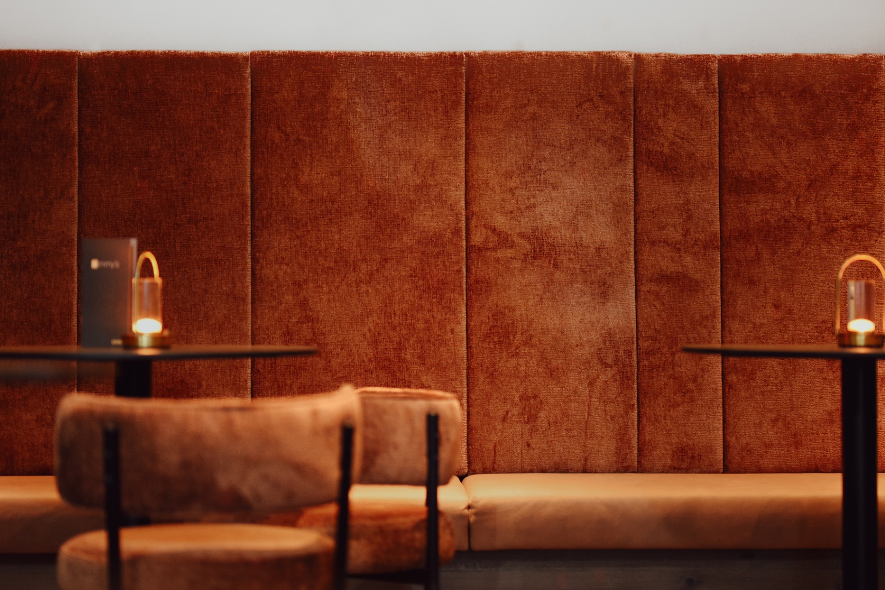 Velvet wall seating and glowing table lamps